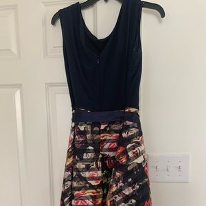 Fun, practical swing skirt flatters.  Size 16, navy top and Multi colored skirt.